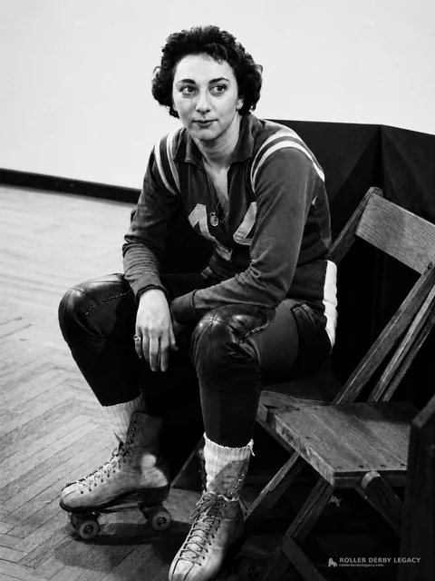 Number 14 Roller Skater Seated by Folding Chairs